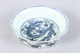 A CHINESE PETAL SHAPED BLUE AND WHITE DRAGON BOWL. 7.5ins diameter.