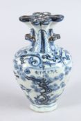 A CHINESE PORCELAIN BLUE AND WHITE VASE of moulded form, with pierced flower stem neck, painted with