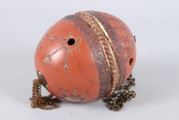 A TURKISH OTTOMAN POTTERY EGG SHAPE hanging on a chain.