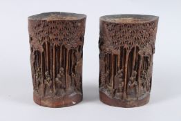 A PAIR OF CHINESE CARVED BAMBOO BRUSH POTS OR VASES, each carved with figures in a landscape.