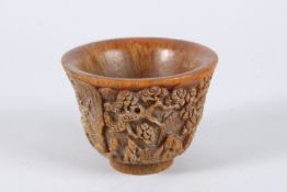 A CHINESE CARVED HORN CIRCULAR BEAKER. 4.5ins diameter.
