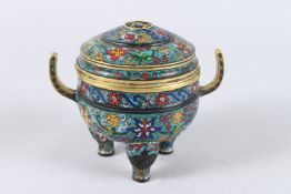 A CHINESE CLOISONNE TWO HANDLED TRIPOD CENSER AND COVER, with floral decoration to the cover and