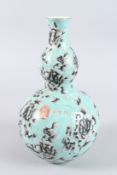A CHINESE PORCELAIN GOURD SHAPE VASE, turquoise ground painted with flowers, four character mark