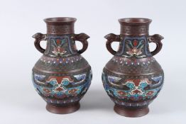 A PAIR OF CHINESE BRONZE AND CLOISONNE TWO HANDLED VASES. 10ins high.