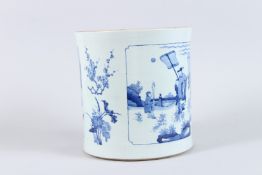 A LARGE CHINESE PORCELAIN BLUE AND WHITE BRUSH POT, painted with figures in a landscape. 24cms