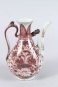 A CHINESE POTTERY EWER, painted with flowers in underglaze iron red. 20cms high.