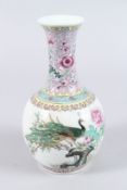 A CHINESE FAMILLE ROSE PORCELAIN BOTTLE VASE, painted with a peacock, flowering tree and