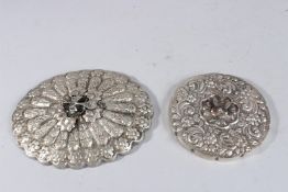 TWO SMALL EGYPTIAN SILVER MIRRORS, oval and circular. 5.5ins x 7ins and 4.5ins diameter.