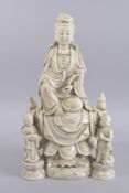 A LARGE BLANC DE CHINE GUANYIN AND CHILDREN, with character marks to reverse, 47cms high.