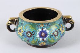 A CHINESE CLOISONNE TWIN HANDLED CENSER, the handles modelled as elephant heads, floal decoration to