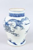 A CHINESE PORCELAIN BLUE AND WHITE JAR, unusually decorated with a moulded design depicting a dragon