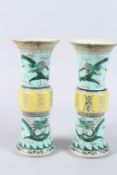 A GOOD PAIR OF 19TH CENTURY CHINESE PORCELAIN FAMILLE VERTE GU VASES, decorated with dragons and
