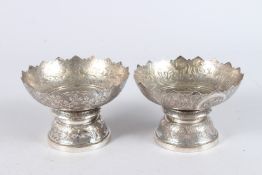 TWO THAI WHITE METAL FOOTED BOWLS. 5ins diameter.