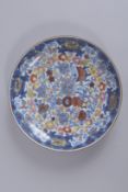 A 19TH CENTURY CHINESE CLOBBERED BLUE AND WHITE PORCELAIN DISH, 25cms diameter.