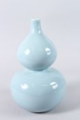 A CHINESE PORCELAIN GOURD SHAPE VASE, with powder blue glaze, square seal mark to the base. 32cms