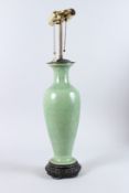 A CHINESE GREEN CRACKLE GLAZE LAMP on a wooden base. Vase 16ins high.