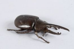 A JAPANESE BRONZE HERCULES BEETLE with articulated body. 4ins long.