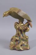 A LARGE JAPANESE GILDED AND ENAMEL PAINTED POTTERY FIGURE OF AN EAGLE ON A ROCKY OUTCROP, 32cms