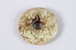 A PIERCED JADE CIRCULAR ROUNDEL. 2ins diameter.
