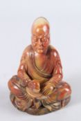 A CHINESE SOAPSTONE LUOHAN FIGURE sitting cross legged. 5.5ins high.