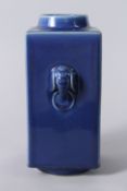 A CHINESE BLUE GROUND SQUARE FORM VASE, with elephant head handles, Kangxi marks to base. 29cms