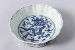 A CHINESE PORCELAIN BRUSH WASHER OR BOWL, the centre painted with a dragon, six character mark to