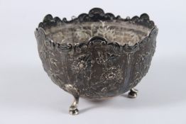 A 19TH CENTURY CHINESE SILVER BOWL, with shaped rim, the body with embossed and chased panels of