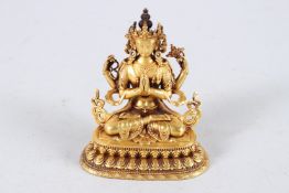 A SMALL TIBETAN GOLD PLATED BUDDHA. 4ins high.