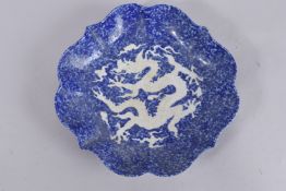 A CHINESE PETAL SHAPE BLUE GLAZE PORCELAIN DRAGON DISH. 32.5cms wide.