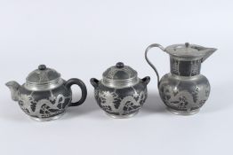 A CHINESE SILVER OVERLAID POTTERY THREE-PIECE TEA SET, TUNG KING SHUN FACTORY.