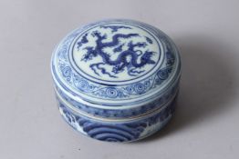 A CHINESE BLUE AND WHITE PORCELAIN CIRCULAR BOX AND COVER, painted with dragons, six character