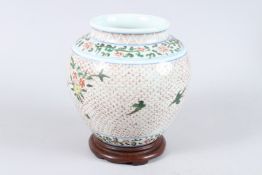 A 19TH CENTURY CHINESE POLYCHROME GINGER JAR AND WOODEN STAND. 8ins high. Bears label: JOHN