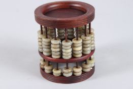 A WOOD AND JADE ABACUS. 4.5ins high.