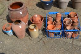 A quantity of terracotta plant pots etc.