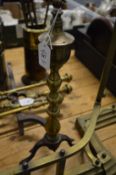 A pair of brass and steel fire dogs.