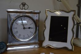 A Jeff Banks mantel clock and a picture frame.