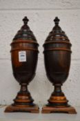 A good pair of lignum vitae turned pedestal urns and covers.