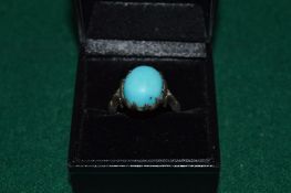 A decorative silver ring.