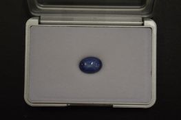 A cabochon star sapphire, boxed with certificate.