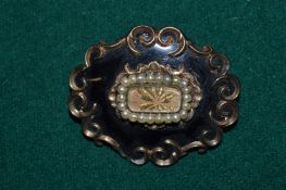Decorative yellow metal and seed pearl brooch.
