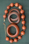 A collection of Kenneth Lane vintage wooden bangles and a necklace.