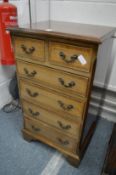 A small reproduction mahogany chest of drawers.