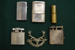 Dunhill and other lighters together with a badge.