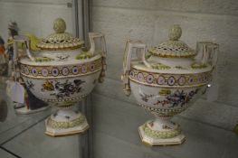 A pair of Augustus Rex porcelain urns painted with flowers (faults).