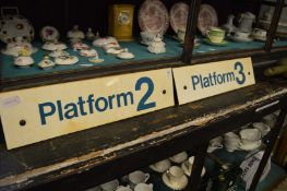 A pair of railway signs, platform 2 and platform 3.