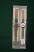 Two Swatch watches.