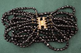 A black bead necklace.