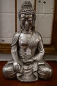 A silvered resin model of a seated Buddha.