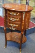 A pair of French style oval three drawer chests with marquetry decoration.