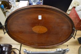 An Edwardian inlaid mahogany oval twin handle tray.